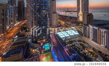 Panoramic view of the Dubai Marina and JBR area and the famous Ferris Wheel aerial day to night timelapse Panoramic view of the Dubai Marina and JBR area and the famous Ferris Wheel aerial day to night timelapse 102840038