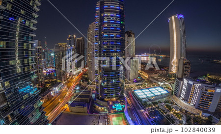 Panorama of the Dubai Marina and JBR area and the famous Ferris Wheel aerial day to night timelapse Panorama of the Dubai Marina and JBR area and the famous Ferris Wheel aerial day to night timelapse 102840039