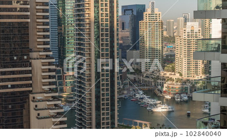 Aerial view on Dubai Marina skyscrapers and the most luxury yacht in harbor timelapse, Dubai, United Arab Emirates Aerial view on Dubai Marina skyscrapers and the most luxury yacht in harbor timelapse, Dubai, United Arab Emirates 102840040