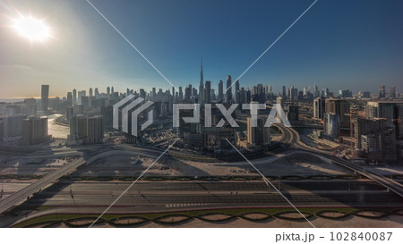 Panoramic skyline of Dubai with business bay and downtown district all day timelapse. 102840087