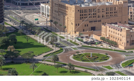 Aerial view of a roundabout circle road intersection in Dubai downtown from above timelapse. 102840114