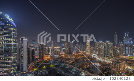 Panorama showing Dubai's business bay towers aerial night timelapse. Rooftop view of some skyscrapers 102840128