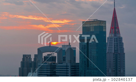 Sunset over financial center of Dubai city with luxury skyscrapers timelapse, Dubai, United Arab Emirates 102840137