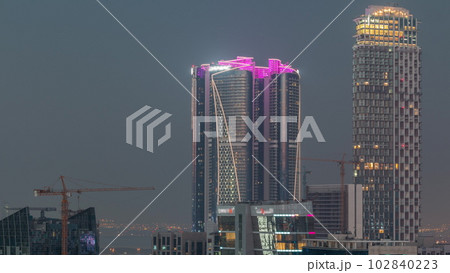 Skyscrapers at the Business Bay aerial day to night timelapse in Dubai, United Arab Emirates 102840223
