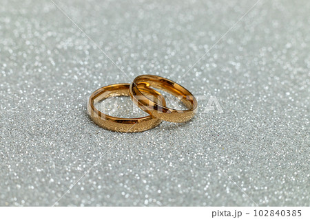Will you marry me. Two golden wedding rings on silver glitter background. Engagement marriage proposal wedding concept. St. Valentine's Day postcard. Banner on valentines day. Copy space 102840385