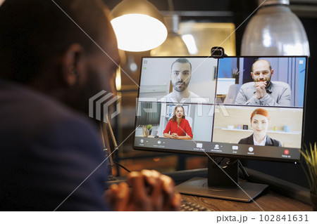 Entrepreneur explaining investment plan to remote team during online videocall meeting conference, working late at night at company strategy to help increase profit. Business concept Entrepreneur explaining investment plan to remote team during online videocall meeting conference, working late at night at company strategy to help increase profit. Business concept 102841631