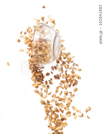 Roasted Peanut bean fall throw up in glass bowl, Roasted Peanut bean float explode, abstract cloud fly. Roasted Peanut beans splash throwing in Air. White background Isolated high speed shutter 102841882