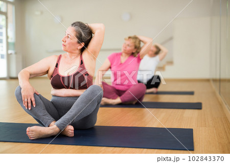 Ladies are sitting in a lotus pose 102843370