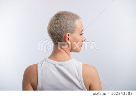 Pretty young woman with a short blond haircut on a white background. Pretty young woman with a short blond haircut on a white background. 102843588