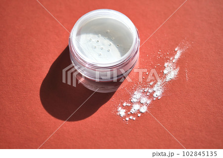 Mineral enzyme powder on a burgundy background. Mineral enzyme powder on a burgundy background. 102845135
