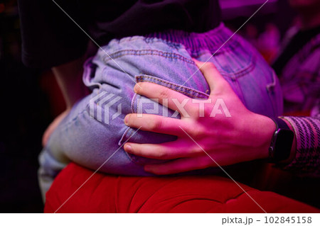 Man's hands grabbing a girl's backside touch. Man's hands grabbing a girl's backside touch. 102845158