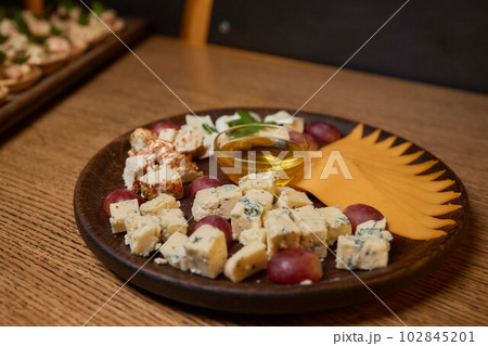 Banquet table with snacks, food on plates, festive table, corporate food 102845201