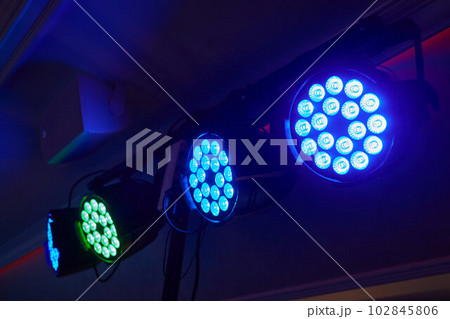 Installation of professional sound, light, video and stage equipment for a concert. Stage lighting equipment is clamped on a truss for lifting. Flight cases with cables. Installation of professional sound, light, video and stage equipment for a concert. Stage lighting equipment is clamped on a truss for lifting. Flight cases with cables. 102845806