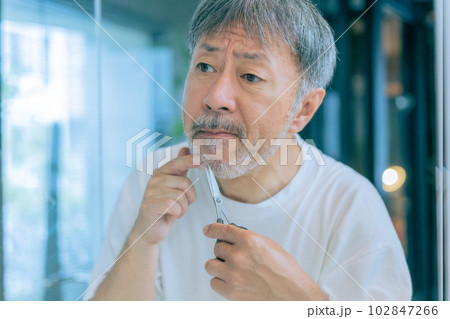 ミドルエイジの男性が髭をお手入れしている様子 102847266