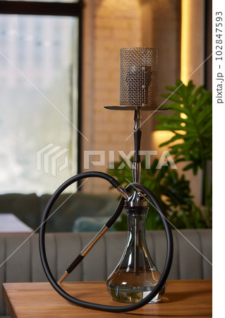 Wood hookah on table in hookah lounge. Wood hookah on table in hookah lounge. 102847593