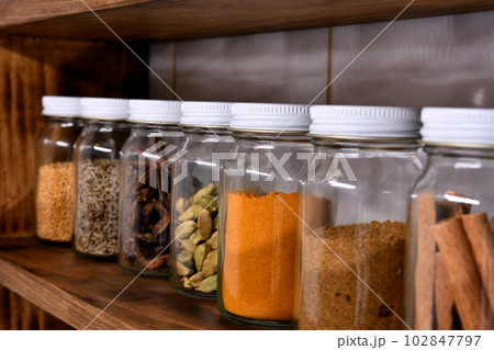 Large collection of spices in small jars on the shelf Stock Photo - Alamy