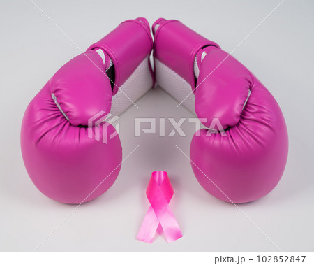 Pink boxing gloves and a pink silk ribbon on a white background. Breast cancer concept.  102852847