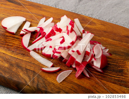 Sliced Radish Roots, Red Root Cuts, Red Radishes Slice Pile, Radis Pieces on Wood Background 102853498