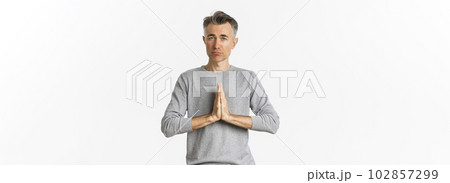 Image of sad middle-aged man begging for help, need something and asking for favour, standing over white background 102857299