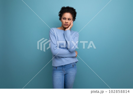 bored young 20s woman with afro hair model appearance thinking in studio bored young 20s woman with afro hair model appearance thinking in studio 102858814