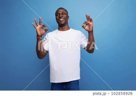 successful optimistic young african guy in white t-shirt 102858926