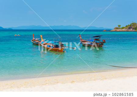 Sunrise Beach in Ko Lipe, Thailand. Long-tail boats in azure water 102861585