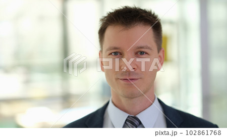 Portrait of young handsome businessman in suit with tie in office Portrait of young handsome businessman in suit with tie in office 102861768