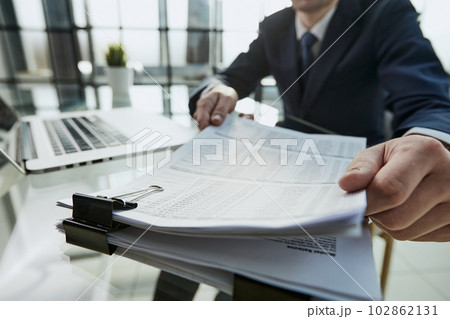 Close-up Of A Businessman Analyzing Financial Report Close-up Of A Businessman Analyzing Financial Report 102862131