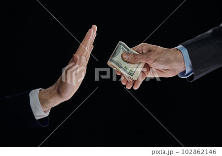 Businessman refusing money offered. Human hands rejecting an offer of money Businessman refusing money offered. Human hands rejecting an offer of money 102862146
