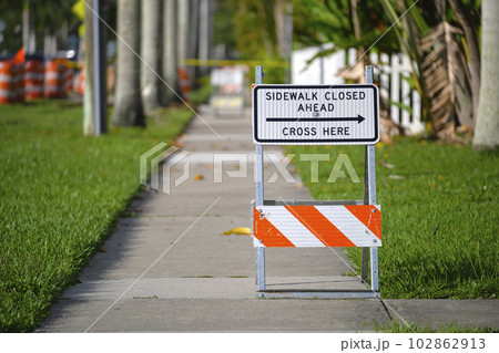 Warning sign that sidewalk is closed at street construction site. Utility work ahead Warning sign that sidewalk is closed at street construction site. Utility work ahead 102862913