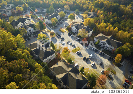 View from above of apartment residential condos between yellow fall trees in suburban area in South Carolina. American homes as example of real estate development in US suburbs 102863015