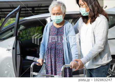 Asian senior woman patient sitting on walker prepare get to her car, healthy strong medical concept. 102863247