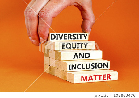 DEI Diversity equity inclusion matter symbol. Concept words DEI diversity equity and inclusion matter on wooden block. Beautiful orange background. Business diversity equity inclusion matter concept. 102863476