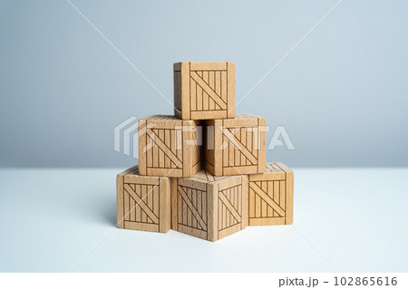 Stack of stacked wooden crates, pyramid of boxes. Order for shipment. Production and freight of goods. Increase in imports and exports, economic recovery. Stack of stacked wooden crates, pyramid of boxes. Order for shipment. Production and freight of goods. Increase in imports and exports, economic recovery. 102865616