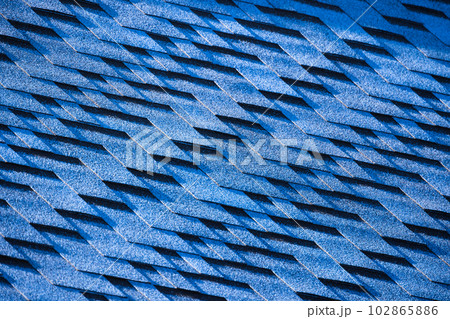 Modern blue roof tiling made of flexible shingles, background photo Modern blue roof tiling made of flexible shingles, background photo 102865886
