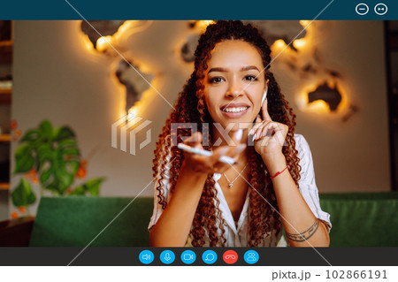 Headshot portrait screen view of young African American woman sit at home talk on video. Headshot portrait screen view of young African American woman sit at home talk on video. 102866191