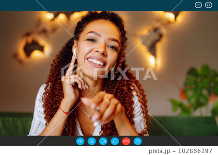 Headshot portrait screen view of young African American woman sit at home talk on video. Headshot portrait screen view of young African American woman sit at home talk on video. 102866197