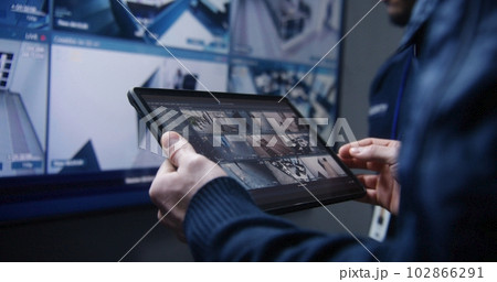 Security operator zoom CCTV cameras using tablet Security operator zoom CCTV cameras using tablet 102866291