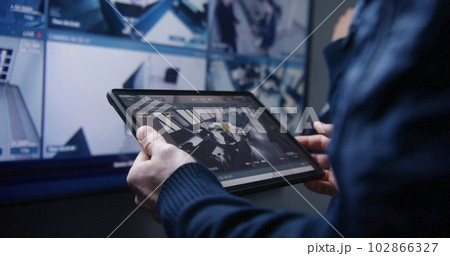 Security operator zoom CCTV cameras using tablet Security operator zoom CCTV cameras using tablet 102866327