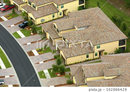 Aerial view of typical contemporary american private house with roof top covered with ceramic shingles and double garage 102866429