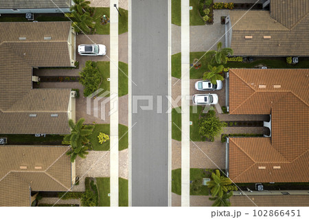 Aerial view of tightly located family houses in Florida closed suburban area. Real estate development in american suburbs Aerial view of tightly located family houses in Florida closed suburban area. Real estate development in american suburbs 102866451