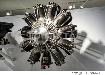 Twelve-cylinder engine of an old-style aircraft in a museum showcase. 102866710