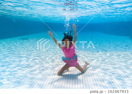 Child in swimming pool on ring toy. Kids swim. 102867933