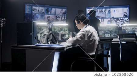 Female officer controls CCTV cameras using tablet 102868620