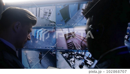 Multi ethnic employees control CCTV cameras Multi ethnic employees control CCTV cameras 102868707