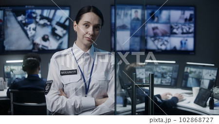 Portrait of female security worker looking at camera Portrait of female security worker looking at camera 102868727