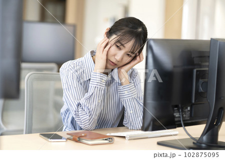 仕事中に頭痛が辛い女性 仕事中に頭痛が辛い女性 102875095