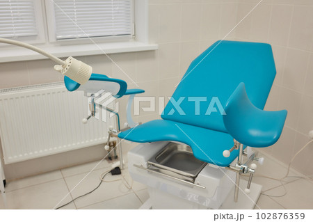 Gynecological cabinet with chair and medical equipment. 102876359