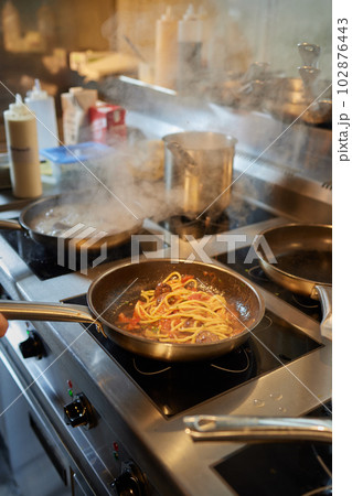 Chef is stirring vegetables in wok on street food concept. 102876443