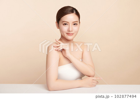 Beautiful young asian woman with clean fresh skin on beige background, Face care, Facial treatment, Cosmetology, beauty and spa, Asian women portrait. Beautiful young asian woman with clean fresh skin on beige background, Face care, Facial treatment, Cosmetology, beauty and spa, Asian women portrait. 102877494
